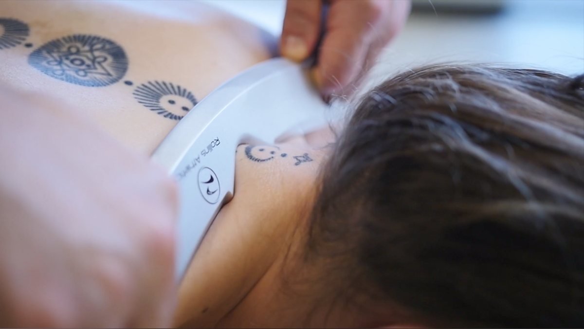 Close-up of the FasciaEdge tool edge gliding on skin